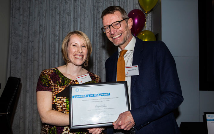 Kitenge Founder Sian collecting her certificate of Fellowship from Alastair Wilson CEO of The School for Social Entrepreneurs at PwC graduation event in London