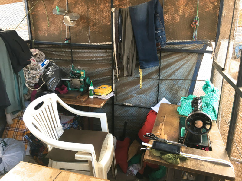 Inside Kitenge tailor Hassan's own workshop in Arusha Tanzania showing his treadle sewing machine