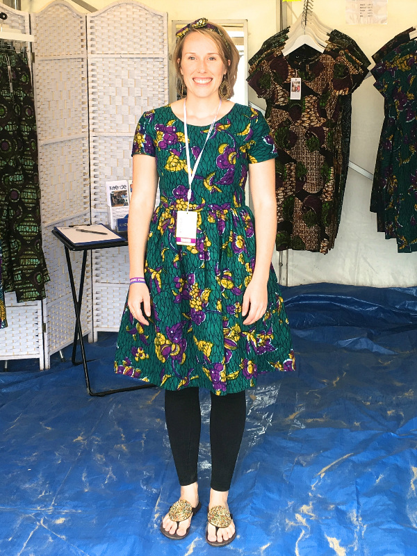 Kitenge founder Sian wearing an African print dress casually with leggings and leather beaded sandals at Looe Music Festival on the beach