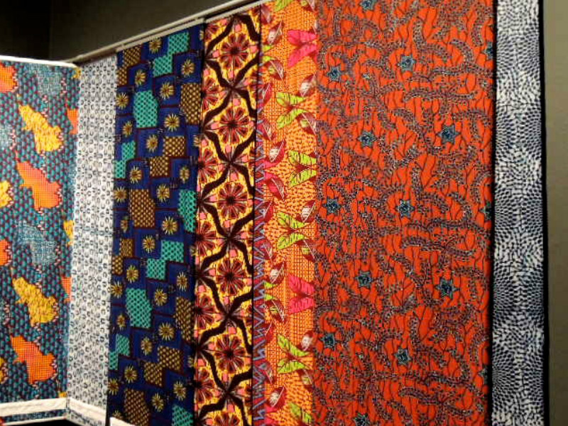 ankara designs printed in Ghana hanging on the wall at the Fashion Cities Africa exhibition at the Brighton Museum in January 2017