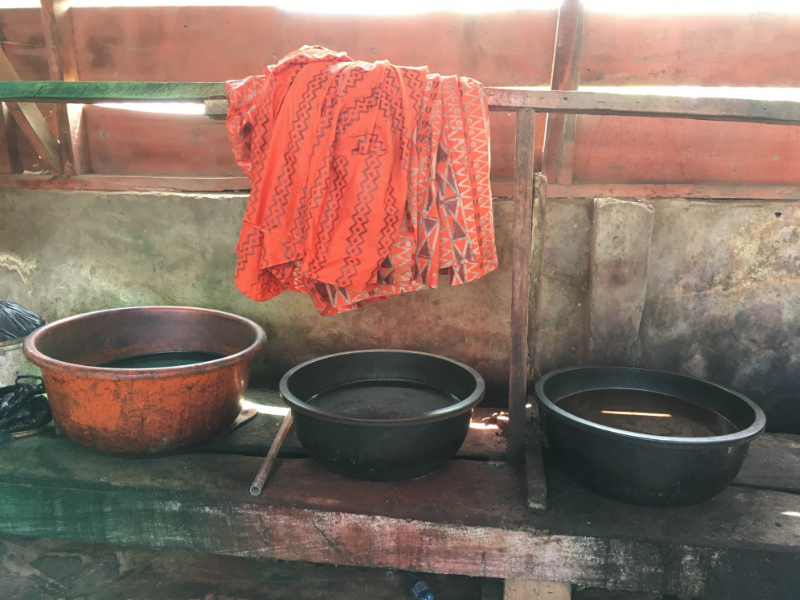 Dye baths inside a traditional batik fabric making workshop in Ghana