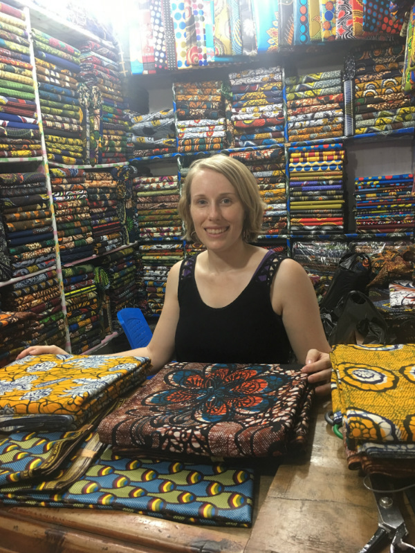 Kitneg Store founder Sian shopping for the best fabrics to make modern african print clothing at the market in Tanzania East Africa 