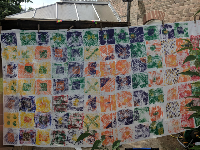 Children's kitenge inspired printing art installation drying outside after class