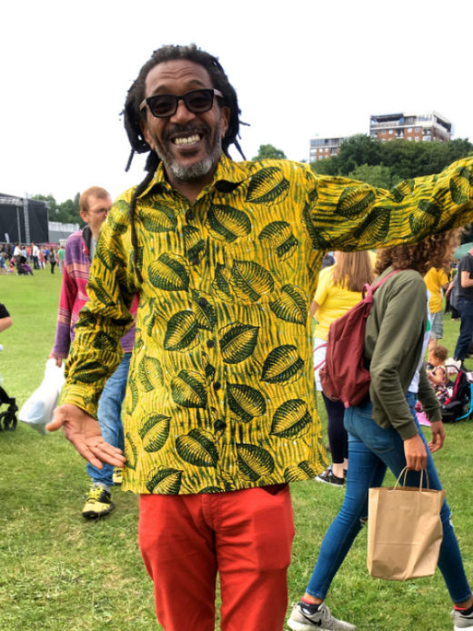 Men's yellow leaf African print long sleeve shirt customer wearing at Africa Oye Festival in Liverpool UK