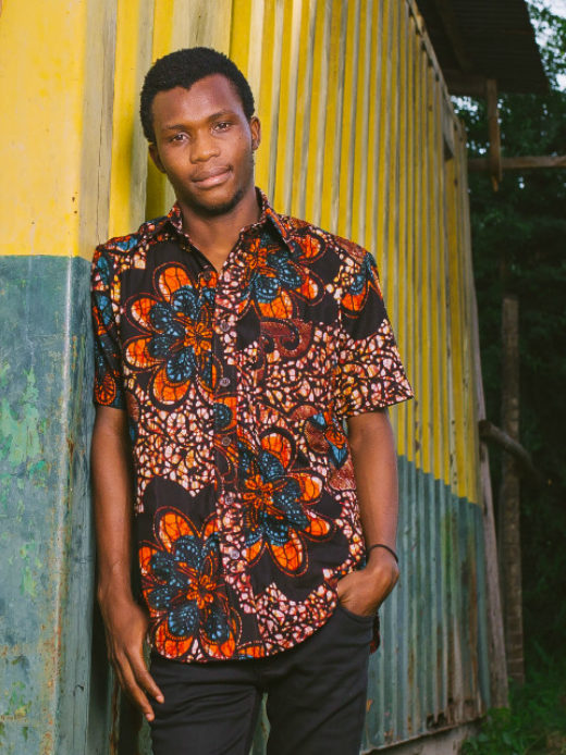 Red Mens African Print Short Sleeve Shirt Model Wearing in Tanzania