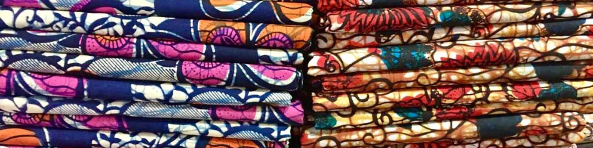 Pile of African wax print fabrics shop in Tanzania