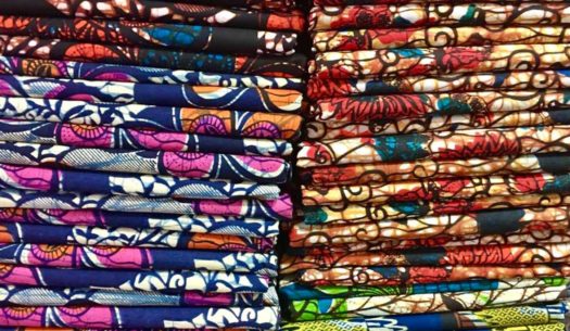 Pile of African wax print fabrics shop in Tanzania