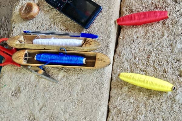 Coloured threads shuttles kente weaving Ghana West Africa