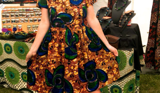 Kitenge customer proudly wearing her new yellow African print dress at Africa Oye Festival in Liverpool, UK
