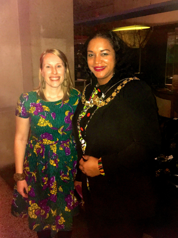 Kitenge founder Sian wearing an African print dress standing with the Lord Mayor of Bristol Green Party Cllr Cleo Lake at Fabric Africa Fashion Show at Bristol Museum