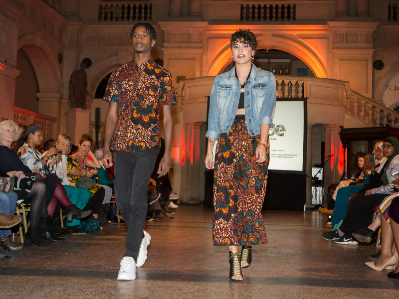 Matching kitenge his and hers African print skirt and shirt worn by models at the Fabric Africa Fashion Show at Bristol Museum