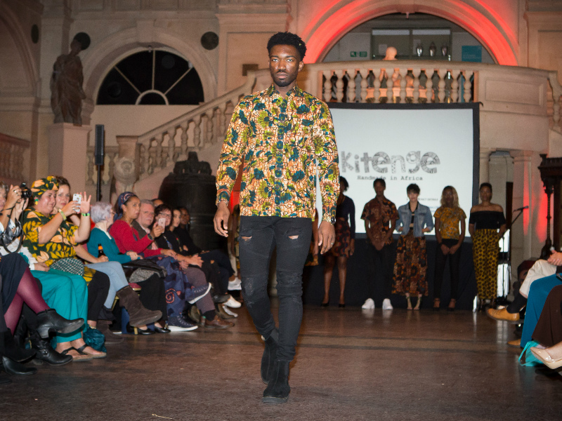 Men's green floral African print long sleeve shirt worn by model on the catwalk at the Fabric Africa Fashion Show at Bristol museum