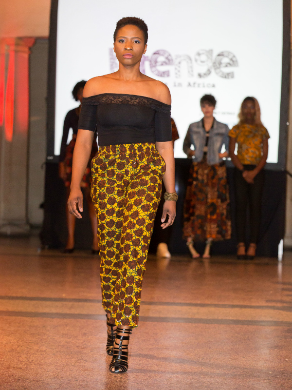 Unisex brown African print trousers/pants worn by a model on the Fabric Africa catwalk at Bristol Museum