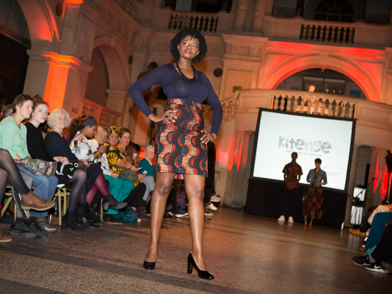 Women's red African print pencil skirt worn by a model at the Fabric Africa Fashion Show at Bristol Museum