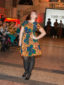A female model wearing a yellow African print fit and flare ankara dress at the Fabric Africa Fashion Show in Bristol Museum UK