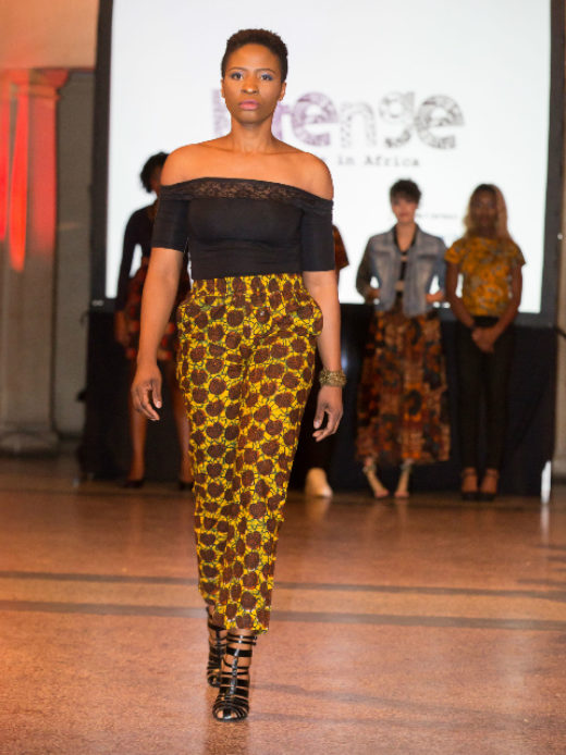 A female model wearing brown African print ankara trousers at the Fabric Africa Fashion Show in Bristol Museum UK