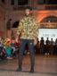 A model wearing a green floral African menswear shirt with long sleeves at the Fabric Africa Fashion Show in Bristol Museum UK