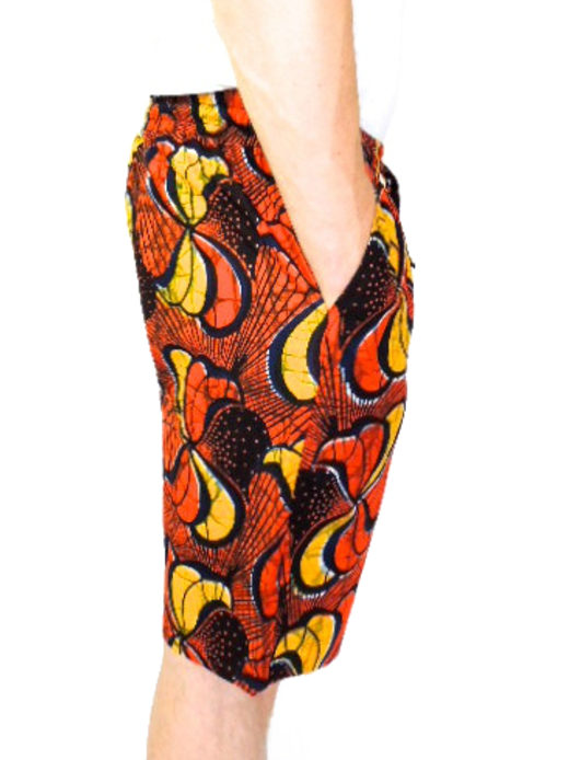 Men's red/yellow African print custom-made shorts model wearing side view