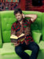 Men's red/green flower custom-made African print short sleeve shirt model wearing sat down reading book