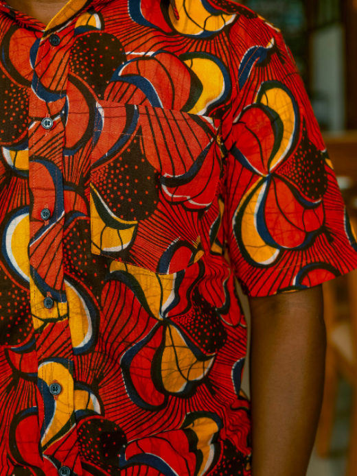Men's red/yellow peacock custom-made African print short sleeve shirt model wearing pocket closeup