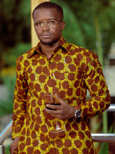 Men's yellow/brown shells custom-made African print long sleeve shirt model wearing front view