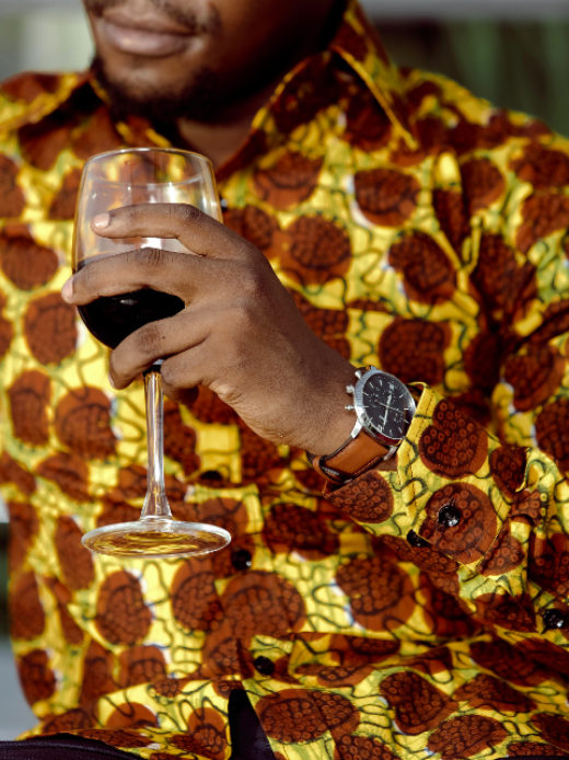 Men's yellow/brown shells custom-made African print long sleeve shirt model wearing front view cuff closeup