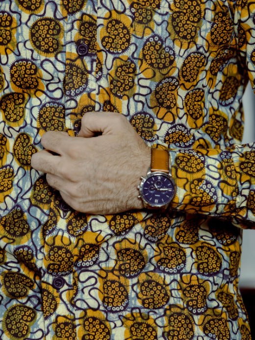 Men's yellow/cream shells custom-made African print long sleeve shirt model wearing cuff closeup