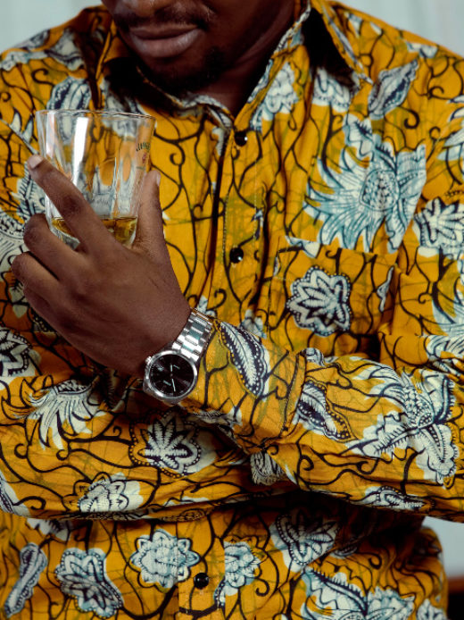 Men's yellow pineapple custom made African print long sleeve shirt model wearing front view closeup arms folded