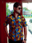 Men's yellow/red/blue peacock custom-made African print short sleeve shirt model wearing front view hand in pocket