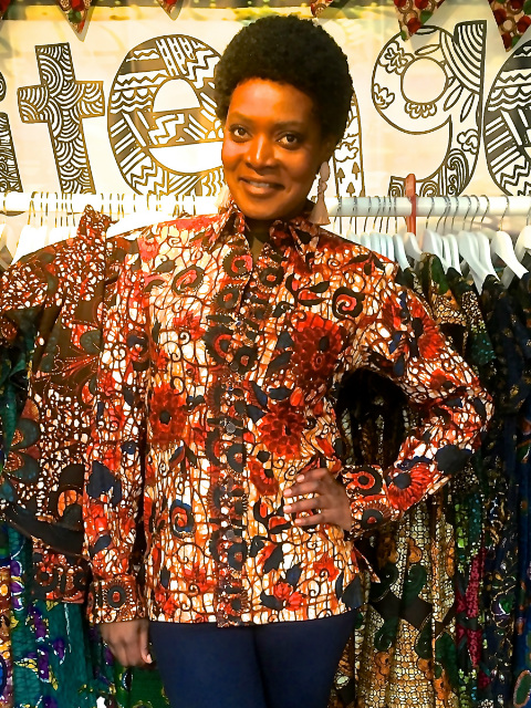 Women's custom made to measure red floral african print long sleeve shirt customer modelling at Africa on The Square event in Trafalgar Square London inside Kitenge's stall