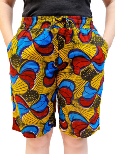 Women's custom made to measure yellow red blue African print shorts model wearing front view hands in pockets
