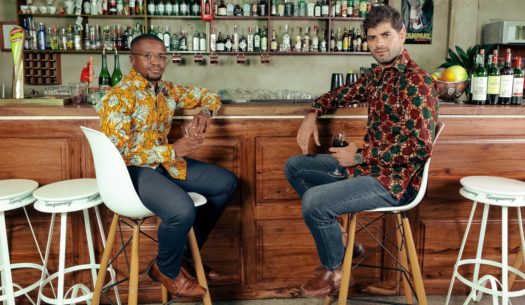 Men's custom-made African print shirts models sat at bar