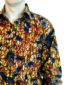Men's ready to wear brown/blue African print long sleeve shirt model wearing front view side pocket closeup
