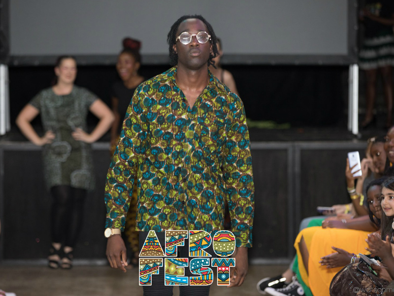 Kitenge African menswear model wearing a dark green African print shirt with long sleeves at the AfroFest Bristol 2019 African fashion show