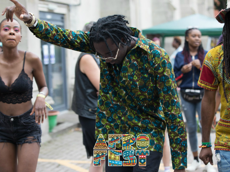 Kitenge model dancing in his new dark green African menswear long sleeve shirt at AfroFest Bristol 2019