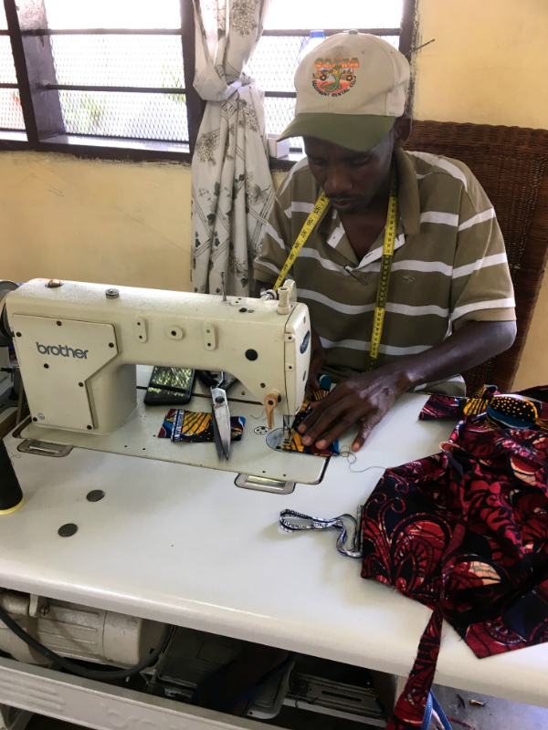 Kitenge tailor tairo making a custom made to measure african print shirt in Tanzania