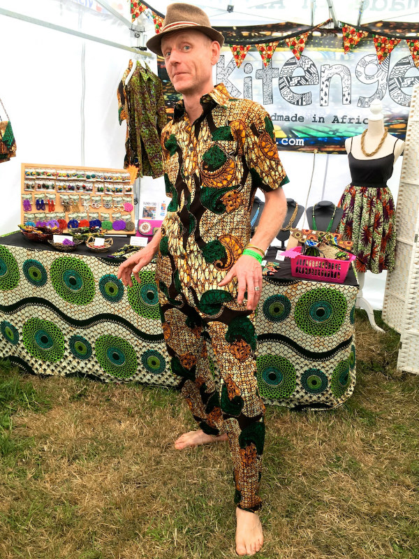 Men's brown African print shirt and trousers customer wearing music festival UK