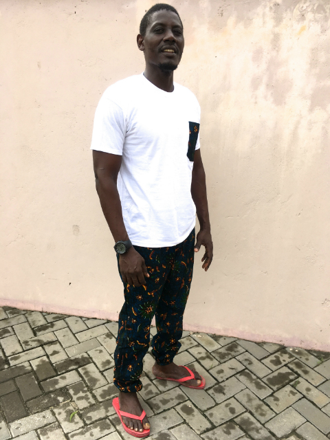 Men's African print trousers and plain white t-shirt outfit model wearing Tanzania
