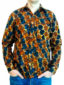 Men's ready to wear red/blue African print long sleeve shirt front view of a model wearing with hands in jean pockets