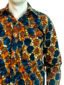 Men's ready to wear red/blue African print long sleeve shirt front view of model wearing closeup of side pocket