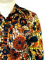 Men's red floral African print shirt with long sleeves model wearing side pocket closeup