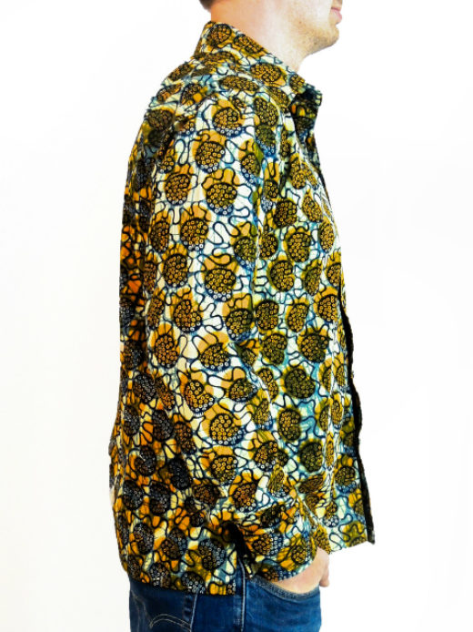 Men's yellow cream ready to wear African wax print long sleeve shirt model wearing side view hands in pockets