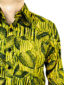 Men's yellow leaf African print shirt with long sleeves model wearing side pocket closeup