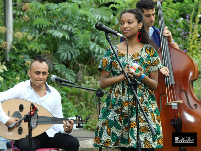 Amira Kheir performing on stage wearing her Kitenge African print dress