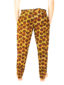 Men's brown/yellow African print trousers model wearing back view
