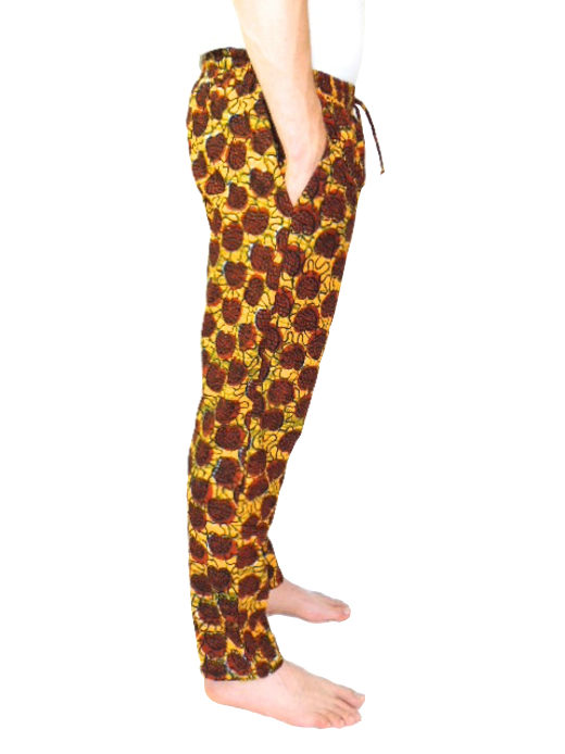 Men's brown/yellow African print trousers model wearing side view