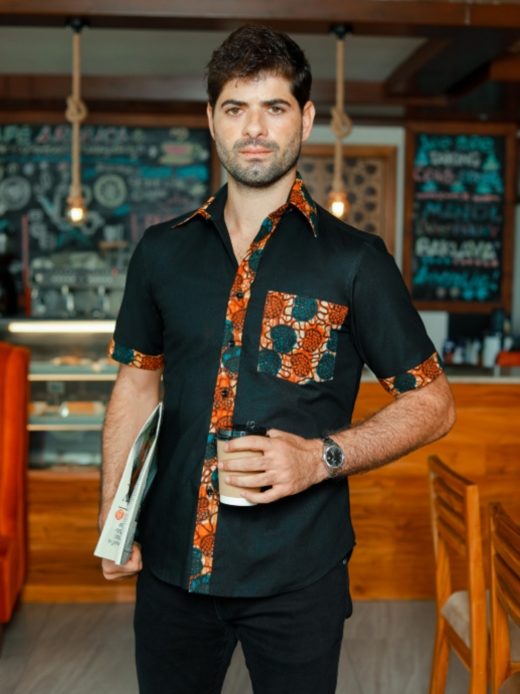 Men's plain black short sleeve shirt with optional African print fabric contrasts model wearing front view standing