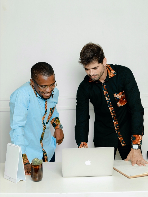 Men's plain coloured custom-made shirts with optional African print fabric contrasts model wearing in office