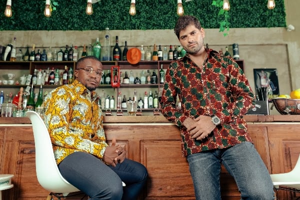 Kitenge Store models wearing African print shirts for men at bar