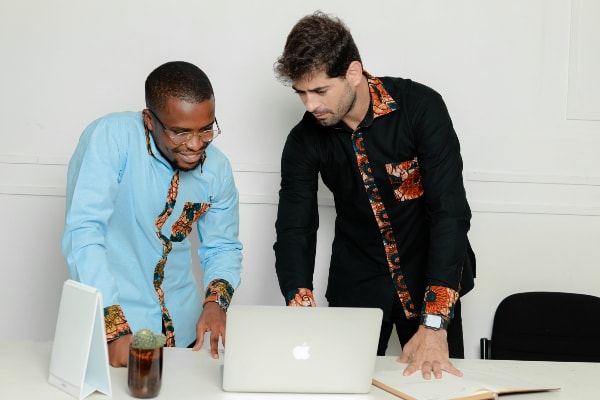 Kitenge Store models wearing plain coloured custom made shirts with optional African wax print fabric contrasts office
